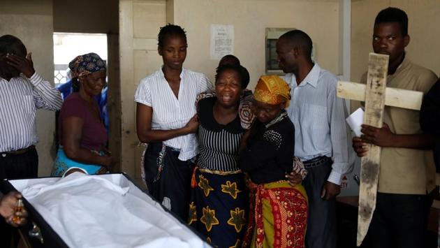 Relatives console family members as they walk past the coffin of Sumba Mufusho, who died after surviving for two days sheltering in a tree in the aftermath of Cyclone Idai, in Beira. (Siphiwe Sibeko / REUTERS) Relatives console family members as they walk past the coffin of Sumba Mufusho, who died after surviving for two days sheltering in a tree in the aftermath of Cyclone Idai, in Beira. (Siphiwe Sibeko / REUTERS)