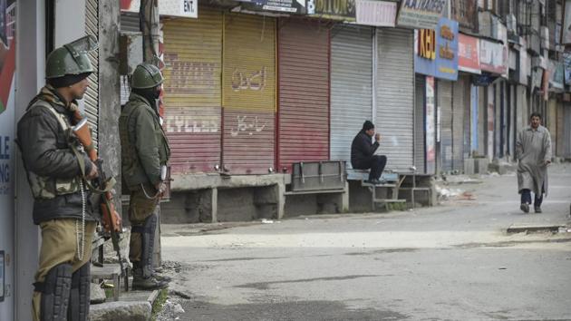 ecurity personnel stands guard during strike called by the separatist groups, to protest against the ban on Jammu and Kashmir Liberation Front (JKLF) led by Yasin Malik, in Srinagar on Sunday.(PTI Photo)