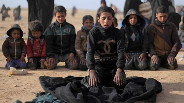 Boys pray together near Baghouz. As the fighting progressed, convoys of trucks from Baghouz started to include hundreds, and then thousands, of surrendering jihadist fighters, many hobbling from their wounds. The SDF said it captured hundreds more in recent weeks who tried to slip through its cordon and escape into Iraq or across the Euphrates into the desert. (Rodi Said / REUTERS) Boys pray together near Baghouz. As the fighting progressed, convoys of trucks from Baghouz started to include hundreds, and then thousands, of surrendering jihadist fighters, many hobbling from their wounds. The SDF said it captured hundreds more in recent weeks who tried to slip through its cordon and escape into Iraq or across the Euphrates into the desert. (Rodi Said / REUTERS)