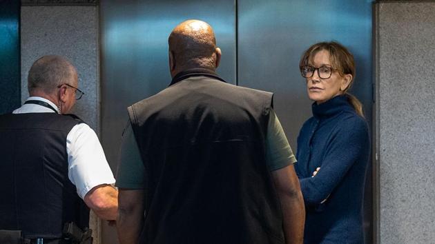 Actress Felicity Huffman is seen inside the Edward R. Roybal Federal Building and U.S. Courthouse in Los Angeles, on March 12, 2019. - Two Hollywood actresses including Oscar-nominated "Desperate Housewives" star Felicity Huffman are among 50 people indicted in a nationwide university admissions scam, court records unsealed in Boston on March 12, 2019 showed. The accused, who also include chief executives, allegedly cheated to get their children into elite schools, including Yale, Stanford, Georgetown and the University of Southern California, federal prosecutors said. (AFP/file) Actress Felicity Huffman is seen inside the Edward R. Roybal Federal Building and U.S. Courthouse in Los Angeles, on March 12, 2019. - Two Hollywood actresses including Oscar-nominated "Desperate Housewives" star Felicity Huffman are among 50 people indicted in a nationwide university admissions scam, court records unsealed in Boston on March 12, 2019 showed. The accused, who also include chief executives, allegedly cheated to get their children into elite schools, including Yale, Stanford, Georgetown and the University of Southern California, federal prosecutors said. (AFP/file)