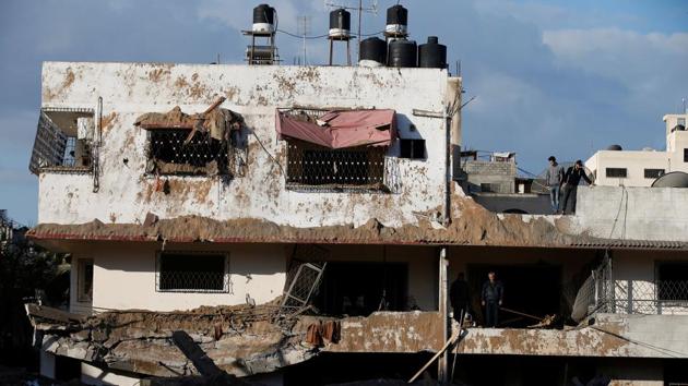 Palestinians inspect their house that was damaged in a nearby Israeli air strike in Gaza City on March 26.(REUTERS) Palestinians inspect their house that was damaged in a nearby Israeli air strike in Gaza City on March 26.(REUTERS)
