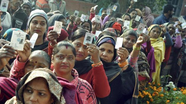 Patiala: Voters show their voting cards as they wait in queues to cast vote in Panchayat Polls, in Patiala, Sunday, Dec. 30, 2018.(PTI)