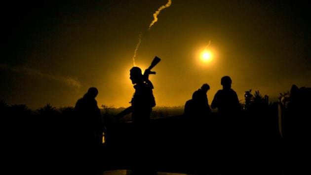 Syrian Democratic Forces fighters watch illumination rounds light up Baghouz. Assad and Iranian allies have sworn to recapture all Syria, while Turkey has threatened to drive out the SDF, which it sees as a terrorist group. The continued presence of US troops in northeast Syria might avert this. (Maya Alleruzzo / AP) Syrian Democratic Forces fighters watch illumination rounds light up Baghouz. Assad and Iranian allies have sworn to recapture all Syria, while Turkey has threatened to drive out the SDF, which it sees as a terrorist group. The continued presence of US troops in northeast Syria might avert this. (Maya Alleruzzo / AP)