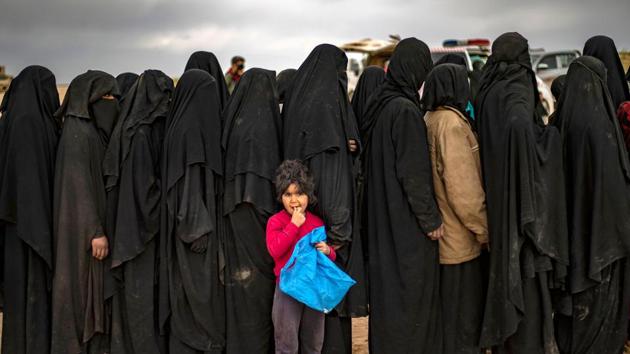 Women and children queue at a screening point as civilians stream out of Baghouz. In 2014, IS grabbed Iraq’s Mosul, erased the border with Syria and called on supporters worldwide to join a jihadist utopia, complete with currency, flag and passports. Its excesses drew an array of forces against it, driving it from Mosul and the Syrian city Raqqa during a year of heavy defeats in 2017 and down the Euphrates to Baghouz. (Delil Souleiman / AFP) Women and children queue at a screening point as civilians stream out of Baghouz. In 2014, IS grabbed Iraq’s Mosul, erased the border with Syria and called on supporters worldwide to join a jihadist utopia, complete with currency, flag and passports. Its excesses drew an array of forces against it, driving it from Mosul and the Syrian city Raqqa during a year of heavy defeats in 2017 and down the Euphrates to Baghouz. (Delil Souleiman / AFP)