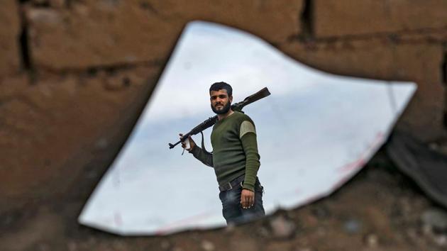 The image of fighter with the SDF is reflected on a broken mirror in the town of Baghouz. Some IS fighters still hold out in Syria’s remote central desert, and in Iraqi cities they have slipped into the shadows, staging shootings or kidnappings. The United States believes the group’s leader, Abu Bakr al-Baghdadi, is in Iraq. (Delil Souleiman / AFP) The image of fighter with the SDF is reflected on a broken mirror in the town of Baghouz. Some IS fighters still hold out in Syria’s remote central desert, and in Iraqi cities they have slipped into the shadows, staging shootings or kidnappings. The United States believes the group’s leader, Abu Bakr al-Baghdadi, is in Iraq. (Delil Souleiman / AFP)
