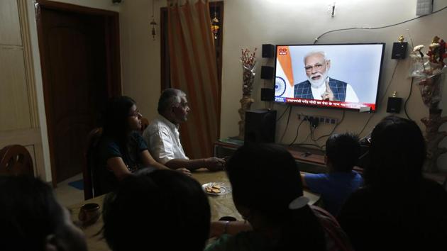 A family in Prayagraj, Uttar Pradesh, watches Prime Minister Narendra Modi addressing the nation on Wednesday when he announced the successful test of an anti-missile weapon.(AP)