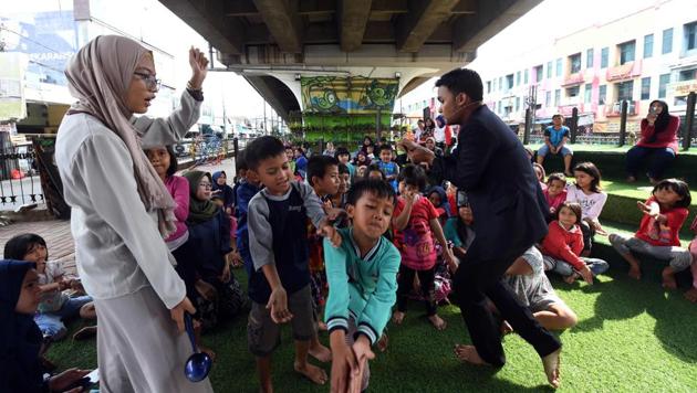 Volunteers conduct a storytelling session with children at an under bridge library called “TBM Kolong” in Ciputat, Indonesia. Despite its unlikely location, the Taman Baca Masyarakat Kolong has been a hit. A shortage of public libraries means it’s one of the few places where kids from this area can read books outside school. (Adek Berry / AFP) Volunteers conduct a storytelling session with children at an under bridge library called “TBM Kolong” in Ciputat, Indonesia. Despite its unlikely location, the Taman Baca Masyarakat Kolong has been a hit. A shortage of public libraries means it’s one of the few places where kids from this area can read books outside school. (Adek Berry / AFP)