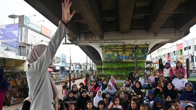 In Hong Kong, a small outdoor library that doubled as a children’s playground was set up under a flyover in the bustling city as part of research into how to better use community spaces, according to a report in the South China Morning Post last year. (Adek Berry / AFP) In Hong Kong, a small outdoor library that doubled as a children’s playground was set up under a flyover in the bustling city as part of research into how to better use community spaces, according to a report in the South China Morning Post last year. (Adek Berry / AFP)