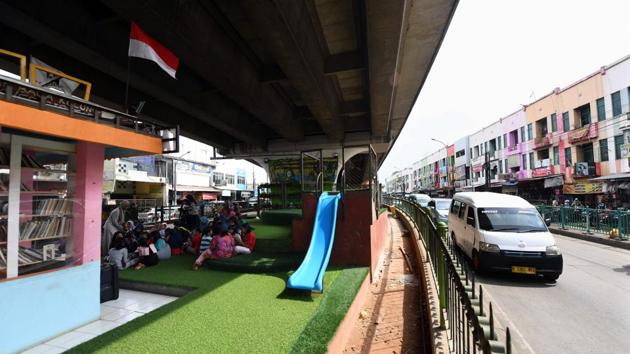 “We wanted to bring books closer to the community,” Devina Febrianti, a library coordinator, told AFP. Several years ago, the flyover in suburb Ciputat, part of Jakarta’s greater metropolitan area, was strewn with rubbish and roamed by intimidating street thugs, Febrianti said. But armed with books and paint, local organisations set about transforming its down-and-out reputation. (Adek Berry / AFP) “We wanted to bring books closer to the community,” Devina Febrianti, a library coordinator, told AFP. Several years ago, the flyover in suburb Ciputat, part of Jakarta’s greater metropolitan area, was strewn with rubbish and roamed by intimidating street thugs, Febrianti said. But armed with books and paint, local organisations set about transforming its down-and-out reputation. (Adek Berry / AFP)