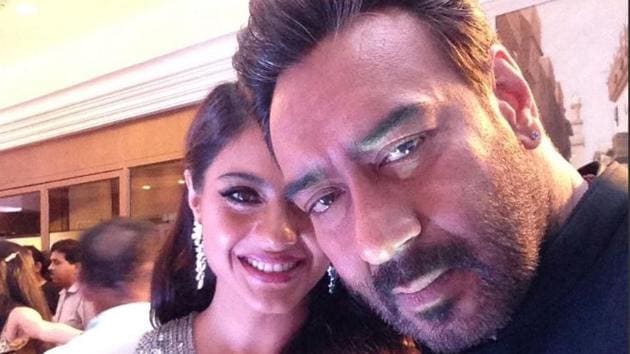 What a cute couple! Actors Kajol  and Ajay Devgn also took to the Twitter Mirror and were caught in a candid-perfect moment. (HT Photo) 