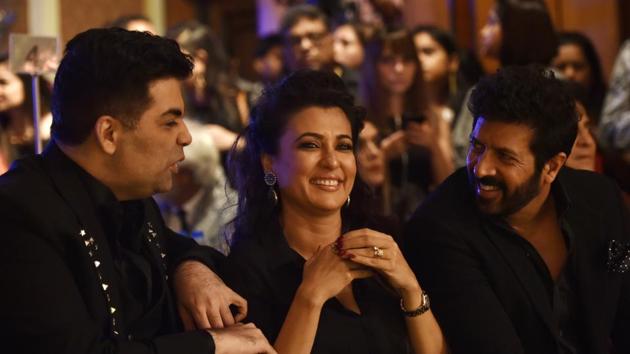 The pretty lady is caught in the middle! Actor Mini Mathur and husband, filmmaker Kabir Khan share a light moment with filmmaker Karan Johar.  (Anshuman Poyrekar/HT Photo) 