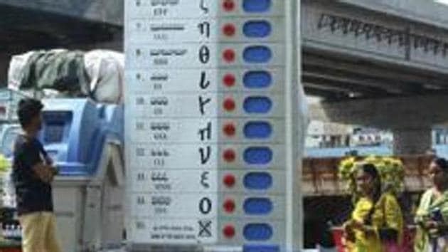 Vijayawada: Pedestrians walk past a replica of Electronic Voting Machine (EVM) installed by the Election Commission of India to create awareness about voting at Benz circle, in Vijayawada, Saturday, March 16, 2019.(PTI)