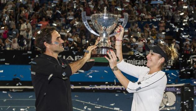 Roger Federer and his mixed doubles partner Belinda Bencic of Switzerland with the Hopman Cup after defeating runners-up Alexander Zverev and Angelique Kerber of Germany in the final on day eight of the Hopman Cup tennis tournament in Perth on January 5, 2019.(AFP)