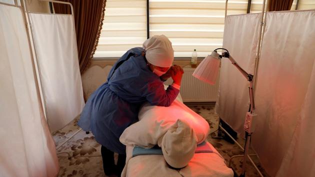 Gulgine Idris, an Uighur reflexologist, treats a patient at a health centre in Istanbul, Turkey. Cengiz said many Uighurs had begun to fear they may be sent back to China. “Turkey was seen as the only country that could stand up to China. In the past year, they have been fearing for their existence in Turkey,” he said. (Murad Sezer / REUTERS) Gulgine Idris, an Uighur reflexologist, treats a patient at a health centre in Istanbul, Turkey. Cengiz said many Uighurs had begun to fear they may be sent back to China. “Turkey was seen as the only country that could stand up to China. In the past year, they have been fearing for their existence in Turkey,” he said. (Murad Sezer / REUTERS)