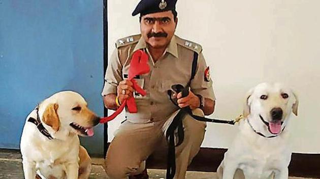 Azamgarh SSP Triveni Singh with the Phantom and Honey.(HT Photo)