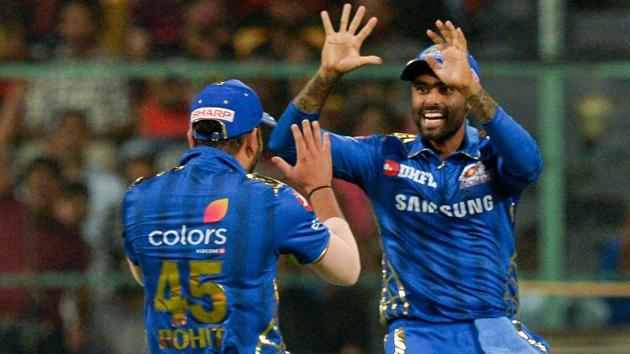 Mumbai Indians fielder Suryakumar Yadav (R) celebrates with his captain Rohit Sharma.(AFP)