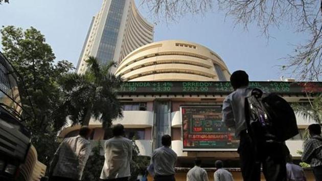 People look at a screen displaying the Sensex results on the facade of the Bombay Stock Exchange (BSE) building in Mumbai,(REUTERS)