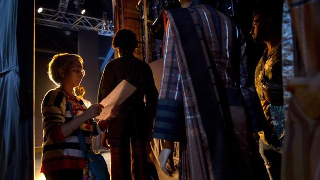 A backstage manager checks the line up moments before a show. Models sashayed down the runway in a riot of color and glitz as Delhi socialites, Bollywood stars and prospective buyers watched for the season’s next “it” items. (Manish Swarup / AP) 