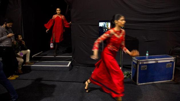 Models rush for a quick change of outfit in between a ramp walk. Vaishali said the saris on the runway paid tribute to the great variety across India of “weaves, textures, drapes and fabrics with every state and every village having its own strongly distinct and contemporary style, alive and evolving.” (Manish Swarup / AP) 