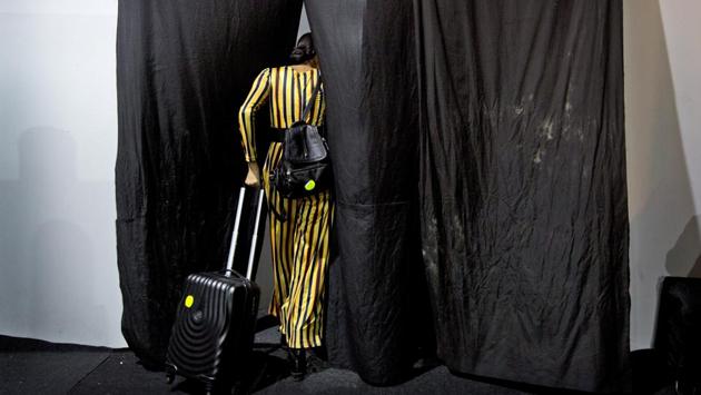 A model leaves the backstage after showcasing creations of Indian designers for the Lotus Makeup India Fashion Week. (Manish Swarup / AP) 
