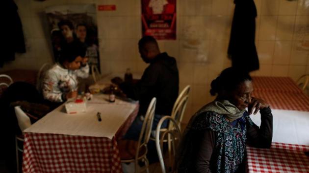Cook Benvinda Mendes, 73, locally known as Totta, takes a break as customers eat at her restaurant. Mendes was born in the Cape Verdean island of Santa Catarina. There she was a construction worker. In the 1980s she moved to Portugal seeking a better life for her family - but when she got to Cova da Moura there was no running water or other basic services. Now, she runs a family restaurant. (Rafael Marchante / REUTERS) Cook Benvinda Mendes, 73, locally known as Totta, takes a break as customers eat at her restaurant. Mendes was born in the Cape Verdean island of Santa Catarina. There she was a construction worker. In the 1980s she moved to Portugal seeking a better life for her family - but when she got to Cova da Moura there was no running water or other basic services. Now, she runs a family restaurant. (Rafael Marchante / REUTERS)