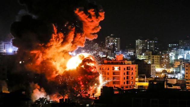Fire and smoke billow above buildings in Gaza City during reported Israeli strikes. (Mahmud Hams / AFP) Fire and smoke billow above buildings in Gaza City during reported Israeli strikes. (Mahmud Hams / AFP)