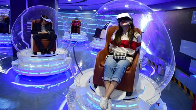 People wearing virtual reality (VR) headsets watch films at a newly opened VR cinema by Er Dong Pictures in Beijing, China. (Lin Hui / Beijing Youth Daily via REUTERS) People wearing virtual reality (VR) headsets watch films at a newly opened VR cinema by Er Dong Pictures in Beijing, China. (Lin Hui / Beijing Youth Daily via REUTERS)