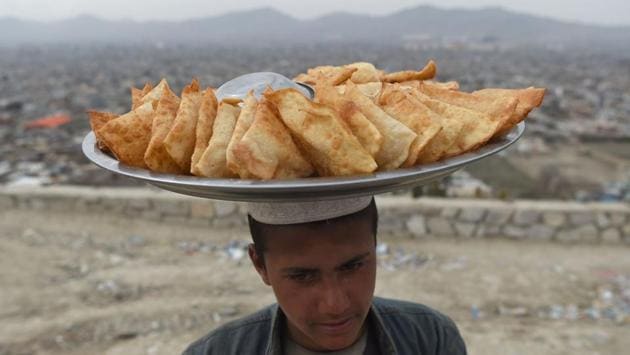 An Afghan samosa vendor looks on as he waits for customers at Wazir Akbar Khan hilltop overlooking Kabul, Afghanistan. (Wakil Kohsar / AFP) An Afghan samosa vendor looks on as he waits for customers at Wazir Akbar Khan hilltop overlooking Kabul, Afghanistan. (Wakil Kohsar / AFP)