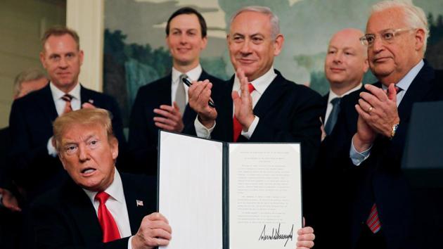 US President Donald Trump holds a proclamation recognizing Israel’s sovereignty over the Golan Heights as he is applauded by Israel’s Prime Minister Benjamin Netanyahu and others during a ceremony in the Diplomatic Reception Room at the White House in Washington. (Carlos Barria / REUTERS) US President Donald Trump holds a proclamation recognizing Israel’s sovereignty over the Golan Heights as he is applauded by Israel’s Prime Minister Benjamin Netanyahu and others during a ceremony in the Diplomatic Reception Room at the White House in Washington. (Carlos Barria / REUTERS)