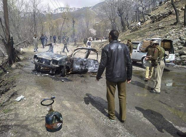 Security personnel inspect the mangled remains of a car which exploded near a CRPF convoy on the Jammu-Srinagar highway at Banihal, in Ramban district of Jammu and Kashmir, Saturday, March 30, 2019. (PTI Photo)(PTI3_30_2019_000046B)(PTI)