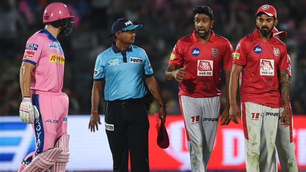 Rajasthan Royals' Jos Buttler (L) exchanges words with Kings XI Punjab's Ravichandran Ashwin (2ndR) . (AFP) Rajasthan Royals' Jos Buttler (L) exchanges words with Kings XI Punjab's Ravichandran Ashwin (2ndR) . (AFP)