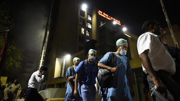 Doctors exit out after a fire broke out at the Trauma Centre in AIIMS, in New Delhi. (Burhaan Kinu / HT Photo) Doctors exit out after a fire broke out at the Trauma Centre in AIIMS, in New Delhi. (Burhaan Kinu / HT Photo)