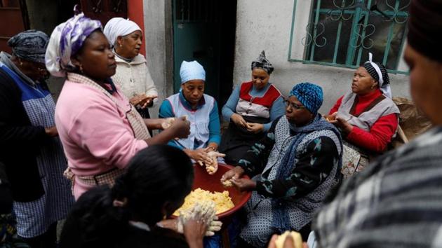 Women prepare corn flour during Santa Catarina celebrations in Cova da Moura. Santa Catarina is one of the most important religious celebrations here and in Cape Verde. Long considered a no-go area by Lisbon residents, Cova Da Moura is a warren of small streets where Cape Verdeans make up two-thirds of the 6,000 residents. (Rafael Marchante / REUTERS) Women prepare corn flour during Santa Catarina celebrations in Cova da Moura. Santa Catarina is one of the most important religious celebrations here and in Cape Verde. Long considered a no-go area by Lisbon residents, Cova Da Moura is a warren of small streets where Cape Verdeans make up two-thirds of the 6,000 residents. (Rafael Marchante / REUTERS)