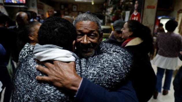 People dance inside Coqueiro, one of the dozens of restaurants in the Cova da Moura. Made famous by Cape Verde’s singing legend Cesaria Evora, ‘morna’ is a musical mainstay here. The more upbeat ‘funana’ and ‘batuque’ styles, which will feature in pop star Madonna’s upcoming album, are also popular. Madonna has had a home in Portugal since 2017. (Rafael Marchante / REUTERS) People dance inside Coqueiro, one of the dozens of restaurants in the Cova da Moura. Made famous by Cape Verde’s singing legend Cesaria Evora, ‘morna’ is a musical mainstay here. The more upbeat ‘funana’ and ‘batuque’ styles, which will feature in pop star Madonna’s upcoming album, are also popular. Madonna has had a home in Portugal since 2017. (Rafael Marchante / REUTERS)