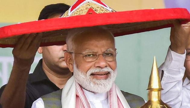 Prime Minister Narendra Modi being felicitated by his party leaders during an election rally ahead of Lok Sabha elections, at Moran in Dibrugarh district of Assam on Saturday.(PTI)