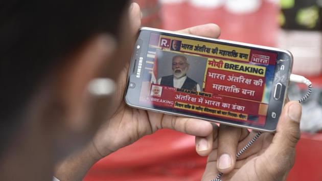 A man watches Prime Minister Narendra Modi addressing the nation during his announcement of “Mission Shakti” on his smartphone, at Daryaganj, in Delhi. (Sanchit Khanna / HT Photo) A man watches Prime Minister Narendra Modi addressing the nation during his announcement of “Mission Shakti” on his smartphone, at Daryaganj, in Delhi. (Sanchit Khanna / HT Photo)