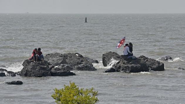 Two couples perched atop rocks in the Arabian Sea at Bandra in Mumbai, Maharashtra. (Satyabrata Tripathy / HT Photo) Two couples perched atop rocks in the Arabian Sea at Bandra in Mumbai, Maharashtra. (Satyabrata Tripathy / HT Photo)