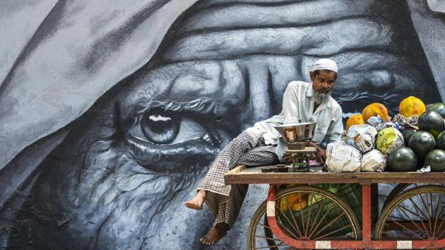 A fruit vendor waits for the customers near a graffiti at Marol in Mumbai, Maharashtra. (Ragul Krishnan / HT Photo) A fruit vendor waits for the customers near a graffiti at Marol in Mumbai, Maharashtra. (Ragul Krishnan / HT Photo)