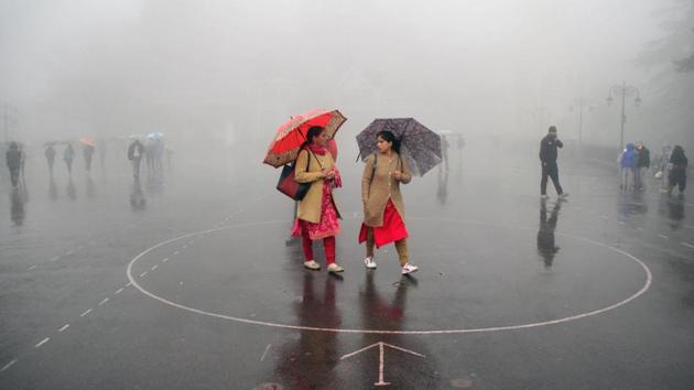 Women carry umbrellas as they walk during rainfall in the northern hill town of Shimla, Himachal Pradesh. (Stringer / AFP) Women carry umbrellas as they walk during rainfall in the northern hill town of Shimla, Himachal Pradesh. (Stringer / AFP)