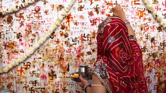 A Hindu woman performs a ritual on the occasion of the “Sheetala Saptami” festival in Ajmer, Rajasthan, where women of the community pray for the well being of their family. (Himanshu Sharma / AFP) A Hindu woman performs a ritual on the occasion of the “Sheetala Saptami” festival in Ajmer, Rajasthan, where women of the community pray for the well being of their family. (Himanshu Sharma / AFP)