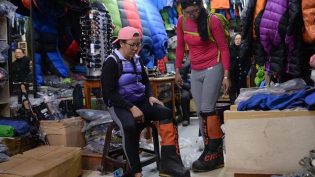 Furdiki Sherpa and Nima Doma Sherpa test equipment at a shop. “Women are rarely encouraged to take up climbing,” said Dawa Yangzum Sherpa, the only internationally certified female mountaineering guide in Nepal. Sherpa society is conservative and patriarchal. Wives and daughters are expected to keep the home fires burning while the men climb mountains. But many die in the process. (Prakash Mathema / AFP)