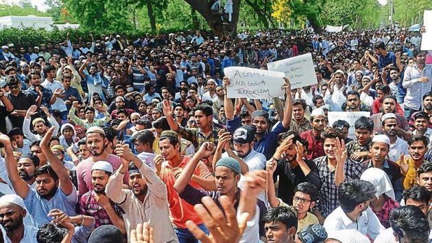 Aligarh Muslim University students staged a protest after parliamentarian Satish Gautam had written to the university last May to explain Muhammad Ali Jinnah’s picture in the student union hall, which is accompanied by those of Mahatma Gandhi and BR Ambedkar(PTI file)