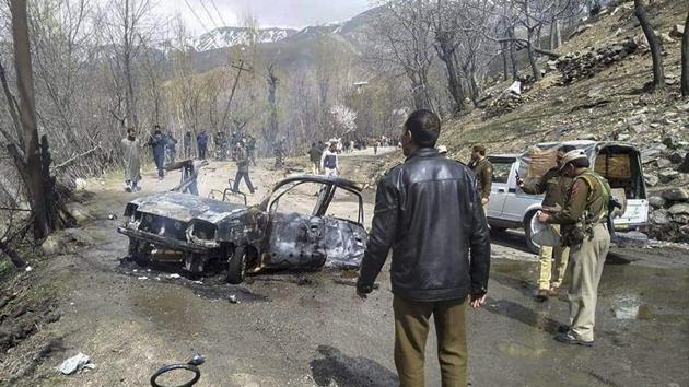 Security personnel inspect the mangled remains of a car which exploded near a CRPF convoy on the Jammu-Srinagar highway at Banihal in Ramban district of Jammu and Kashmir on March 30.(PTI) Security personnel inspect the mangled remains of a car which exploded near a CRPF convoy on the Jammu-Srinagar highway at Banihal in Ramban district of Jammu and Kashmir on March 30.(PTI)