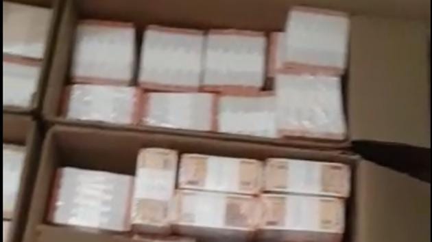 Tax officials said their teams were able to seize bundles of currency notes packed in cartons and gunny bags.(Screengrab)