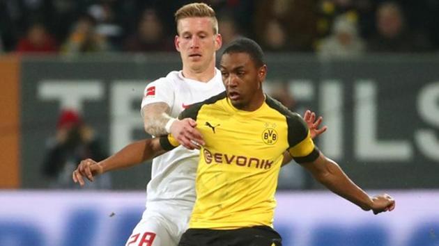 Borussia Dortmund's Abdou Diallo in action with Augsburg's Andre Hahn.(REUTERS)