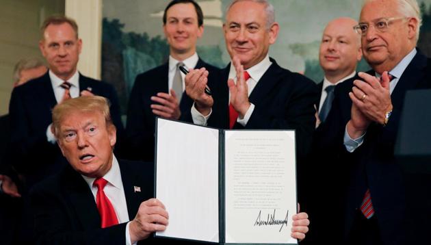 US President Donald Trump holds a proclamation recognizing Israel's sovereignty over the Golan Heights as he is applauded by Israel's Prime Minister Benjamin Netanyahu and others during a ceremony in the Diplomatic Reception Room at the White House in Washington, March 25, 2019(REUTERS)