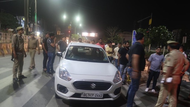 Noida Police with the car of an aide of Union Minister J P Nadda after they recovered the vehicle which had been robbed Tuesday night.(HT PHOTO) Noida Police with the car of an aide of Union Minister J P Nadda after they recovered the vehicle which had been robbed Tuesday night.(HT PHOTO)