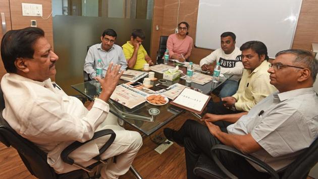 Senior Congress leader Prithviraj Chavan (centre), former chief minister of Maharashtra, interacts with HT staff at the HT office on Boat Club road on Monday. (Pratham Gokhale/HT Photo) 