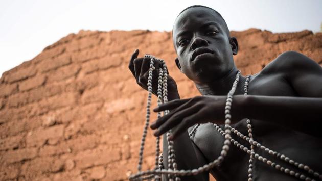A Broto musician adorns himself with his seed necklaces in a ruined house. In January, Bambari was the scene of clashes between the Blue Helmets and elements of the Central African Peace Unit (UPC), one of 16 armed groups that control most of the territory. The looting that ensued also destroyed the musicians’ instruments. (Florent Vergenes / AFP) A Broto musician adorns himself with his seed necklaces in a ruined house. In January, Bambari was the scene of clashes between the Blue Helmets and elements of the Central African Peace Unit (UPC), one of 16 armed groups that control most of the territory. The looting that ensued also destroyed the musicians’ instruments. (Florent Vergenes / AFP)