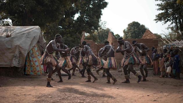 A group of Broto traditional musicians perform with bells made from palm leaves tied to their ankles in Bambari. Once ready, the musicians began their performance. Not long after a crowd approached, some sketched dance steps, happy to hear music rather than the rattle of gunfire. (Florent Vergenes / AFP) A group of Broto traditional musicians perform with bells made from palm leaves tied to their ankles in Bambari. Once ready, the musicians began their performance. Not long after a crowd approached, some sketched dance steps, happy to hear music rather than the rattle of gunfire. (Florent Vergenes / AFP)